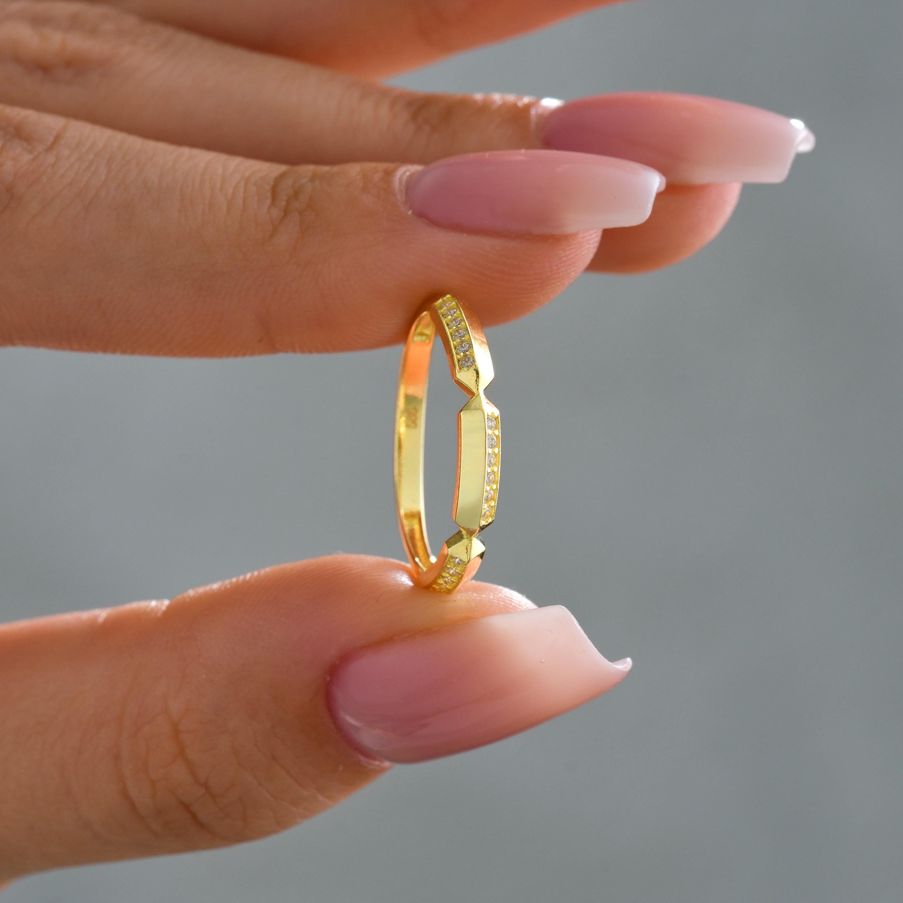 asymmetric gold band showing offset bead set round cz diamonds and smooth gold segments, minimalist stacking gold ring