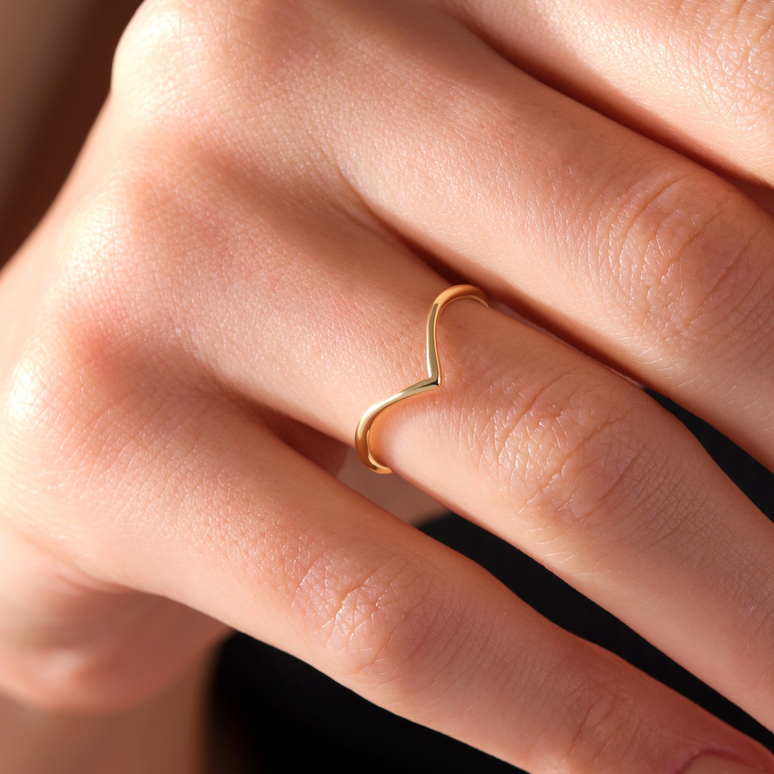 Embrace a modern and stylish look with our Solid Gold V-Shaped Stacking Ring. Its shiny gold material and clean V shape give it a cool and straightforward style that effortlessly complements any outfit.