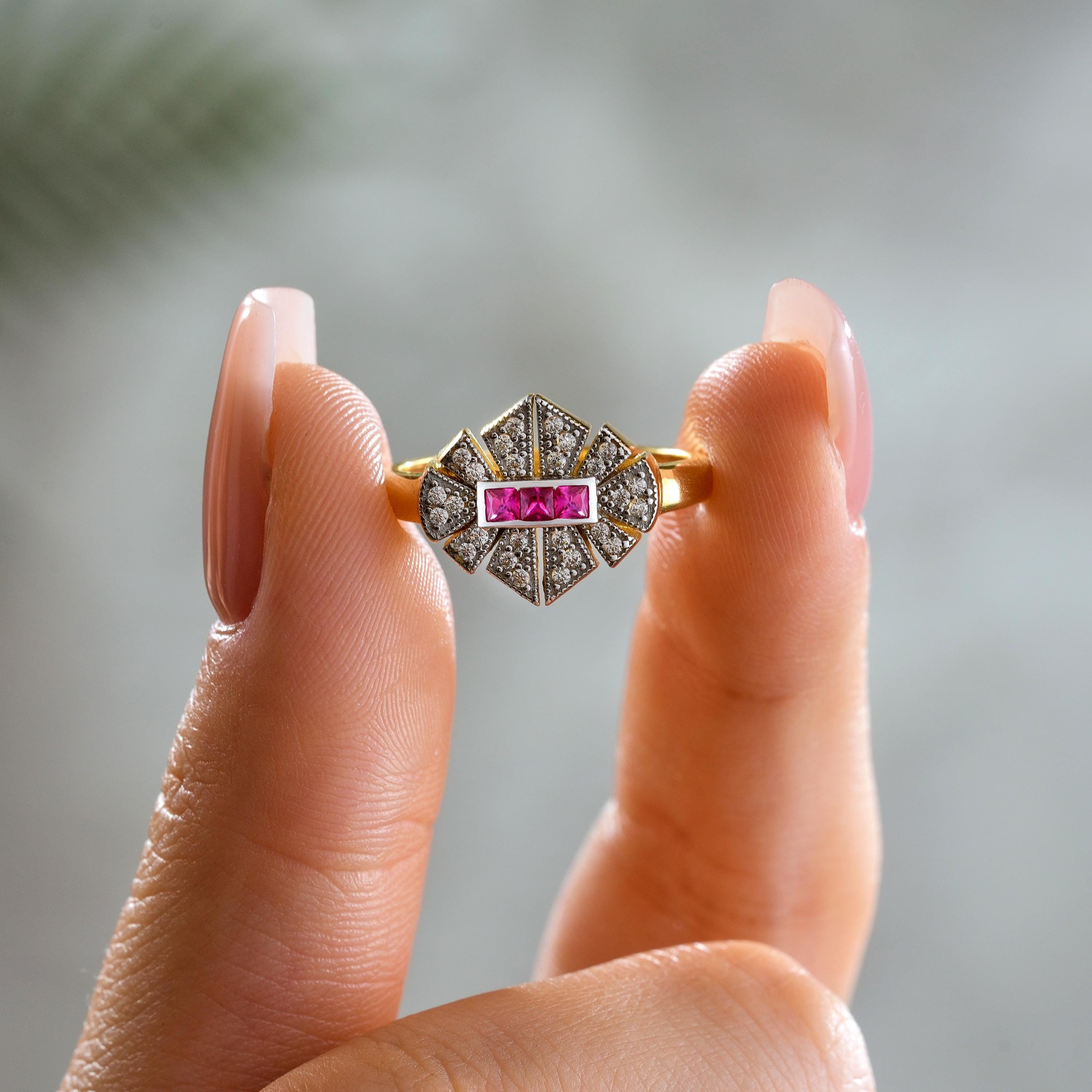 solid gold art deco cluster ring with pink princess cut center stones and pavé round zirconia