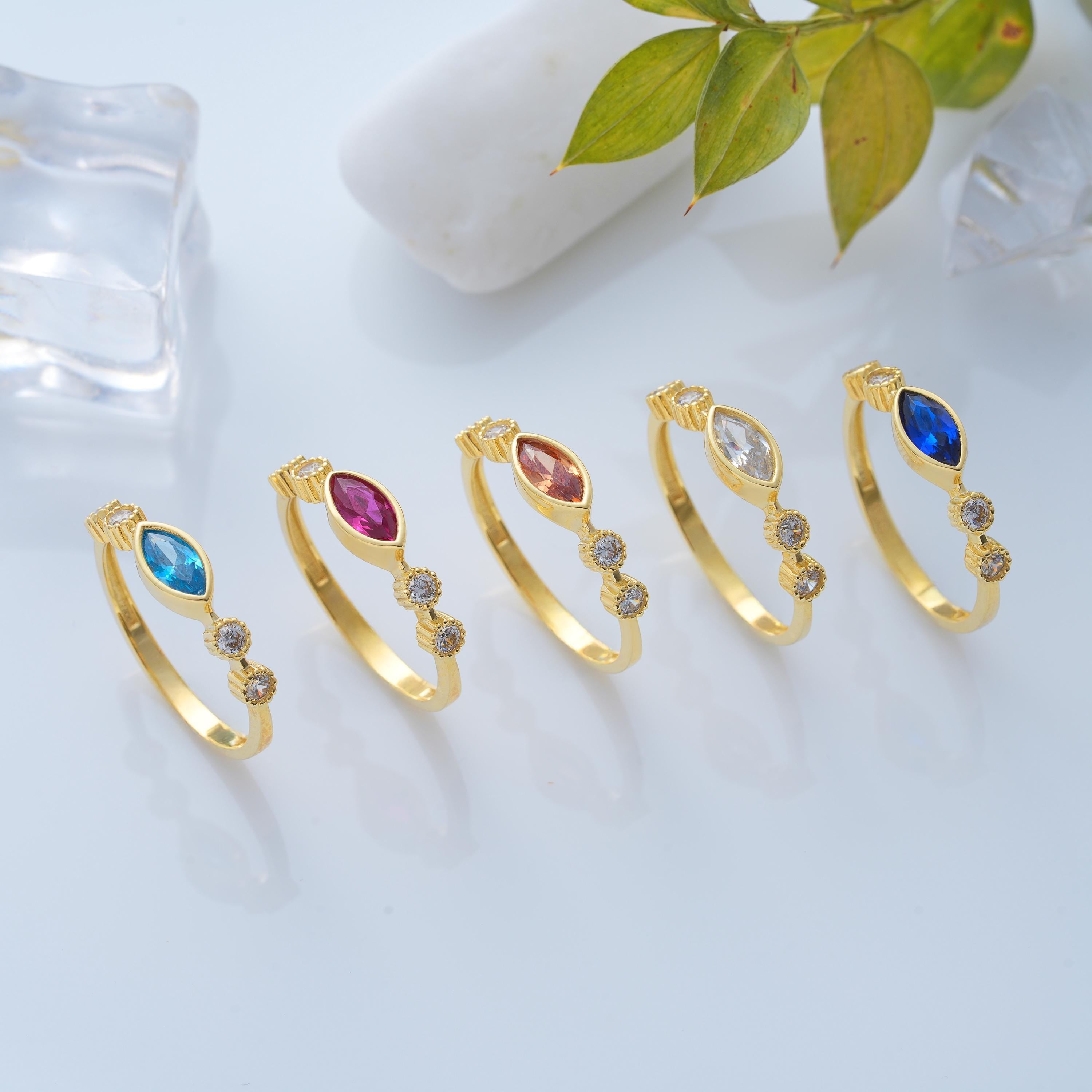 five marquise bezel solid gold rings with customizable stone colors