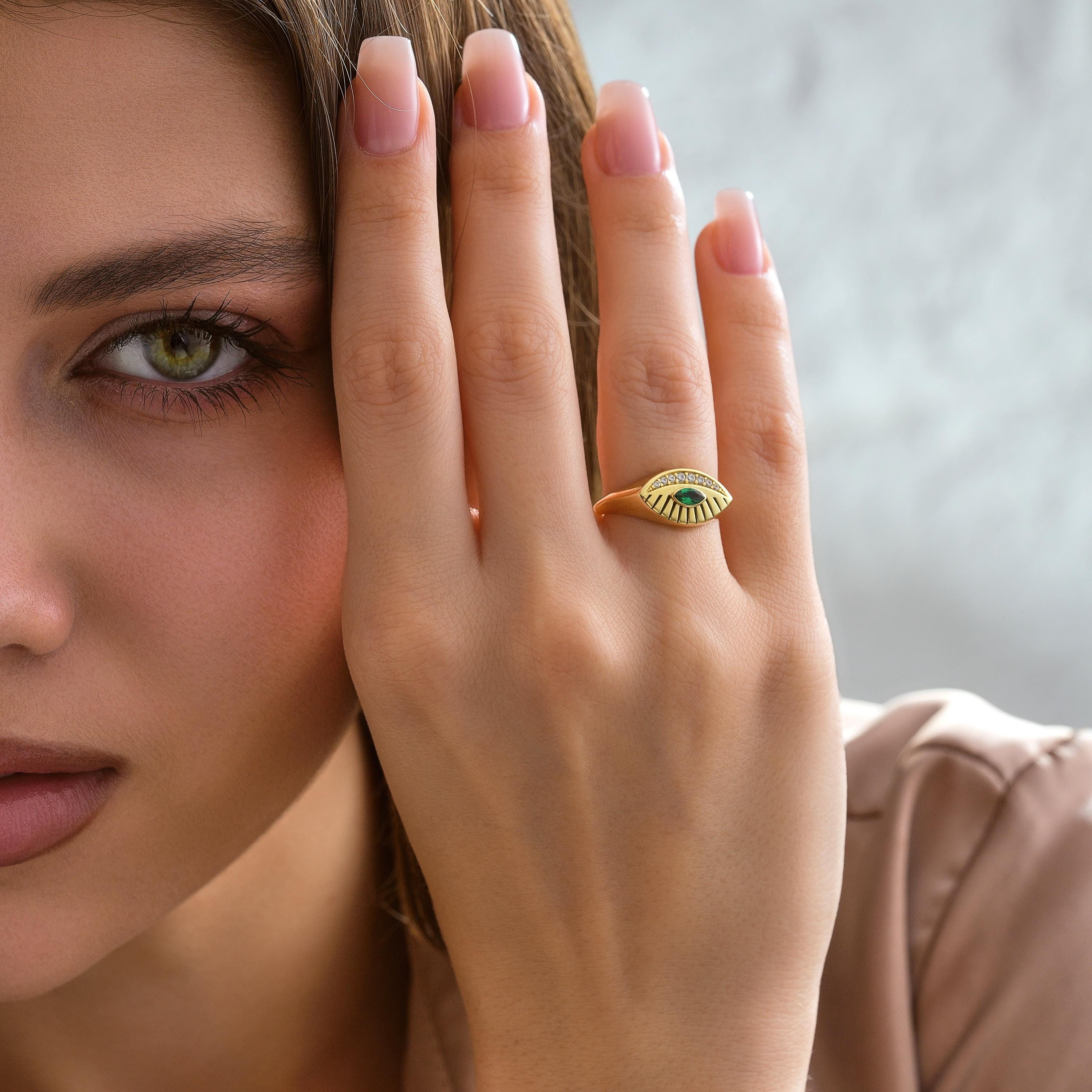 marquise emerald gemstone with engraved top and pave diamond accent stones