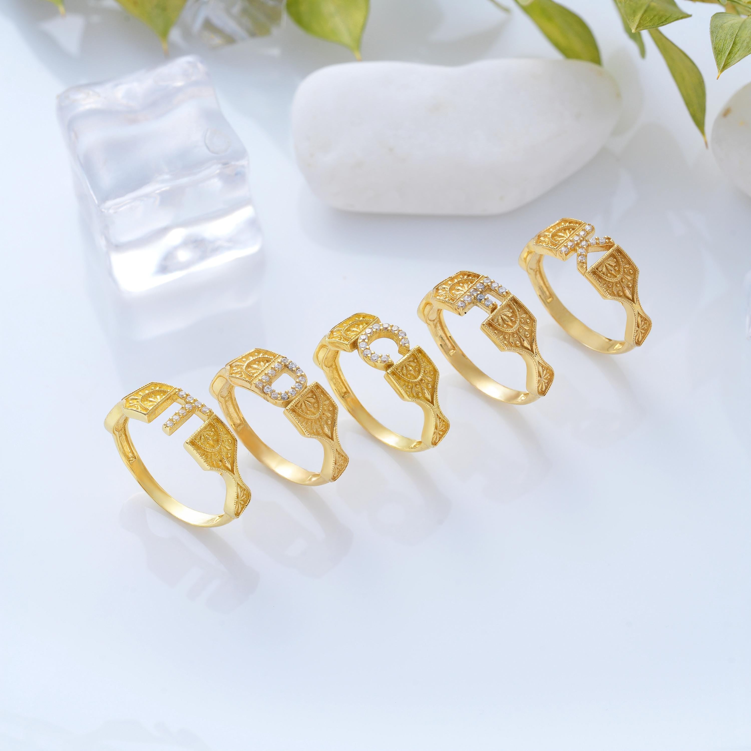 multiple engraved gold initial rings showing letter options